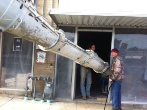 Then they put a giant pipe into the building, and Zac wheelbarrowed concrete into the hole. And Kyle. Zac and Kyle. Two men, filling the hole.